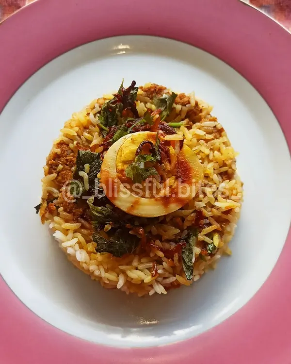 My special Mince Chicken Biryani, a unique twist on the classic dish. I layer aromatic basmati rice with flavorful minced chicken, herbs, and a perfectly cooked egg for a complete and satisfying meal. This is a crowd-pleaser that brings comfort and celebration to your plate.