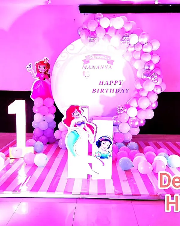 This princess theme party combines characters from different fairy tales like Frozen and The Little Mermaid. I created a full stage with a custom backdrop, multiple character cutouts, and a large marquee number '1' for a truly royal first birthday.