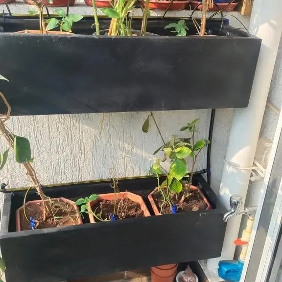 This setup shows our automatic drip irrigation system integrated into tiered balcony planters. The discreet tubing delivers water directly to the soil in each pot, ensuring even the plants on the upper levels receive consistent moisture without any manual watering.