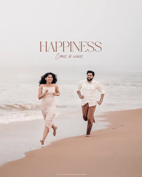 Happiness truly comes in waves. This image captures a moment of pure, unscripted joy as the couple runs along the Honnavara shoreline, their laughter echoing the sound of the sea.