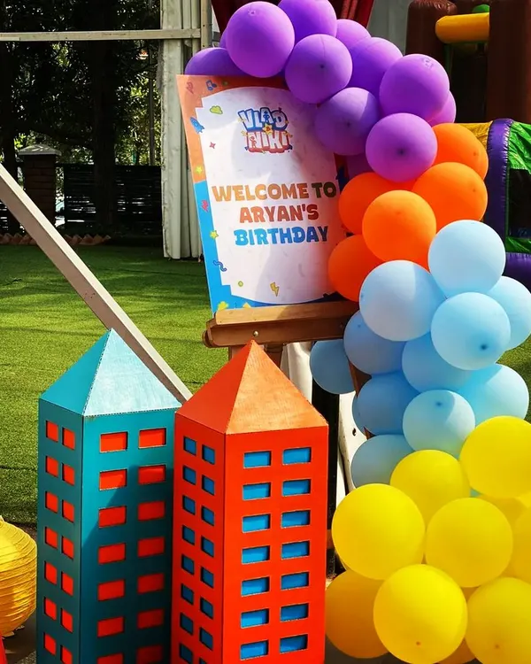 A cheerful welcome sign for Aryan's birthday party, framed by a colorful balloon arch. I paired it with my custom-built cardboard skyscrapers to immediately establish the fun, city-superhero theme for arriving guests.