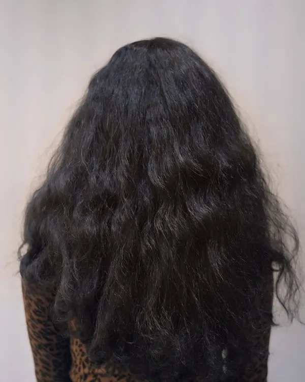 Before: This client was dealing with frizz and unruly texture. She wanted a smoother, more manageable style without harsh chemicals.