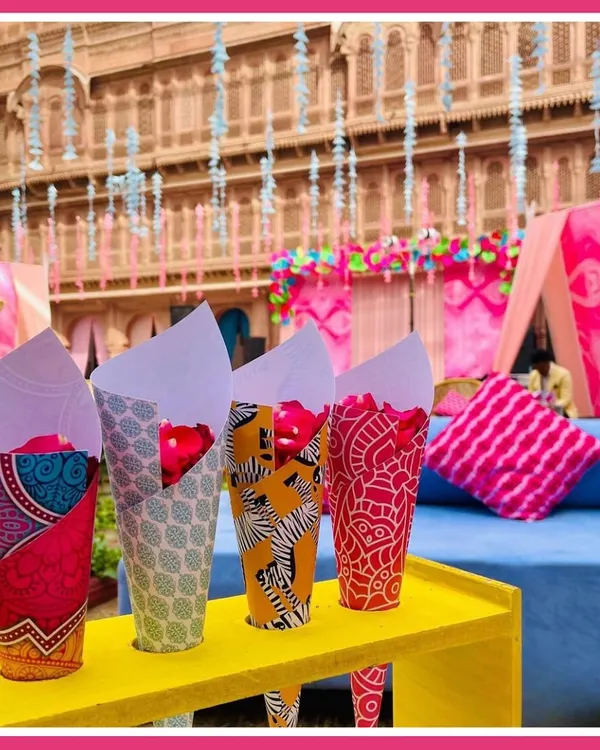 The little details make the theme. For our Rajasthani mela, we used custom-printed paper cones filled with fresh rose petals, adding a pop of color and tradition for guests to enjoy.