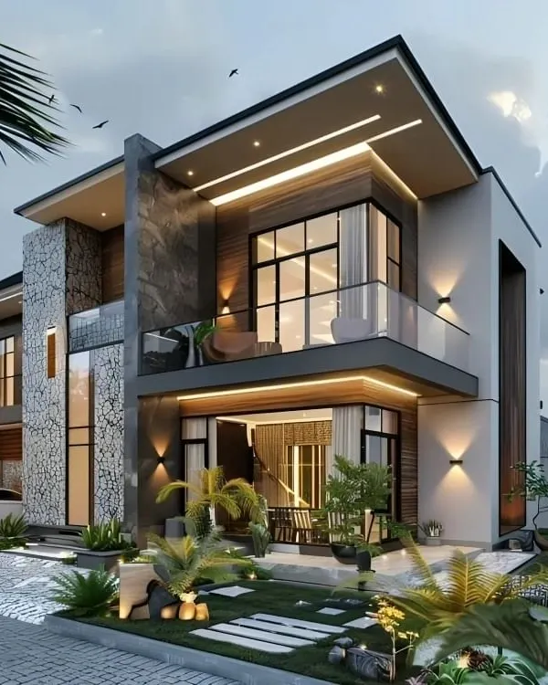 This modern two-story villa showcases our signature style, blending natural stone cladding, warm wood accents, and extensive glass. The exterior lighting design, featuring soffit and wall-mounted fixtures, creates a dramatic and welcoming ambiance after sunset, highlighting the home's architectural lines.