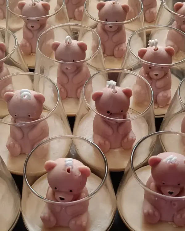 A large batch of my teddy bear jar candles, prepared as return favors for a birthday party. Each bear is carefully placed inside a modern glass jar.