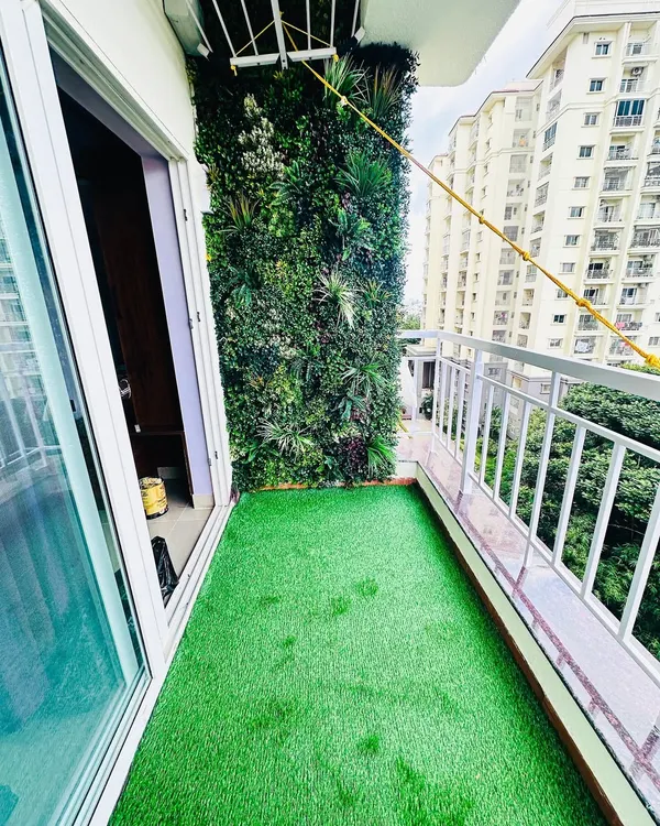 A popular combination for our clients: a lush artificial turf floor paired with a dense, multi-textured vertical garden wall. This instantly turns a simple apartment balcony into a private green nook.