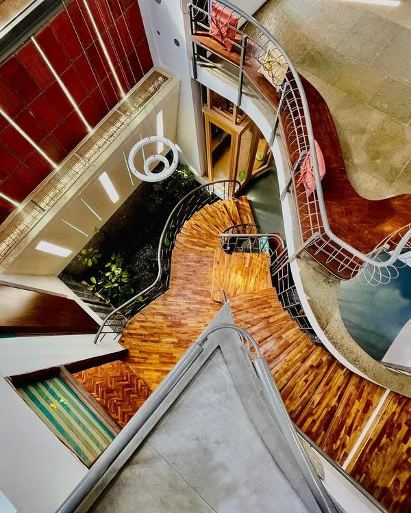 We design spaces that encourage you to flow, not just walk. This top-down view captures the organic geometry of a staircase as it winds through the home, a perfect example of creating fluid movement in architecture.