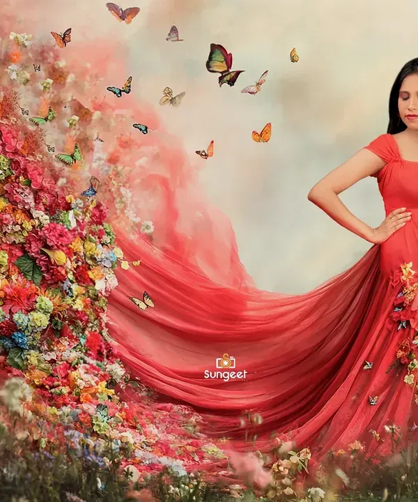 A truly magical moment captured in our studio. We use creative elements like this flowing red gown and a cascade of flowers and butterflies to create fine art pregnancy portraits that feel like a fairytale.