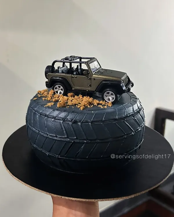 This cake was a special request for my brother's birthday. It's designed to look like a rugged jeep tire, complete with cookie crumble "dirt" and a toy jeep on top.