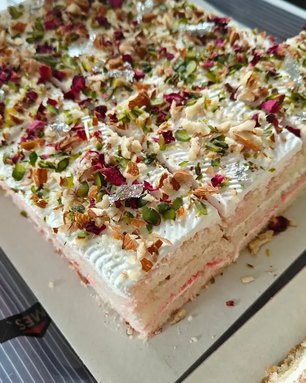 Our signature Rasmalai Pastry is a bestseller for a reason. It has layers of soft, cardamom-infused sponge, light whipped cream, and is generously garnished with nuts, rose petals, and silver leaf.