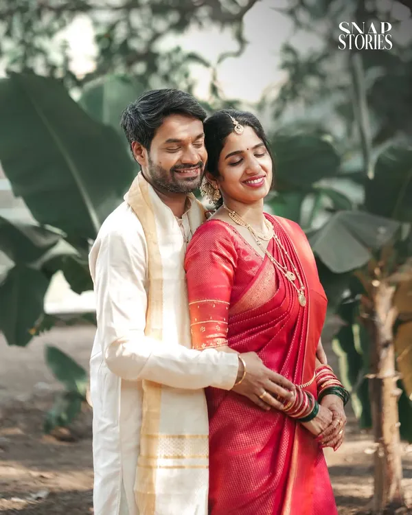 A serene portrait of a South Indian couple in a lush, green setting. We love using natural environments to create calm and romantic wedding photos.
