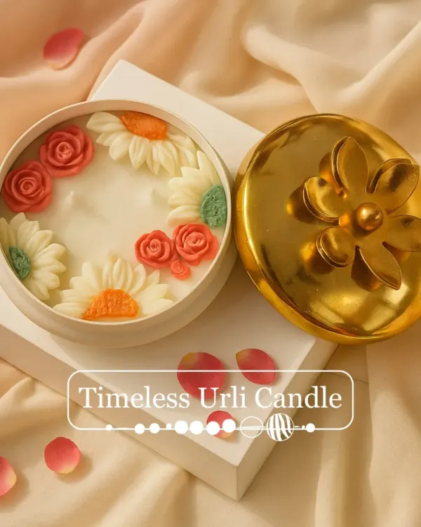 My Timeless Urli Candle, unlit to show the intricate detail of the hand-sculpted wax roses and daisies. It sits beautifully in a reusable container with a golden floral lid, making it a perfect festive decor item.