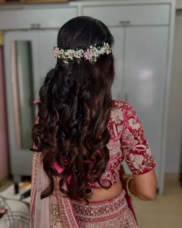 Soft, romantic curls crowned with a delicate fresh flower tiara. This hairstyle is perfect for a daytime engagement or garden wedding.