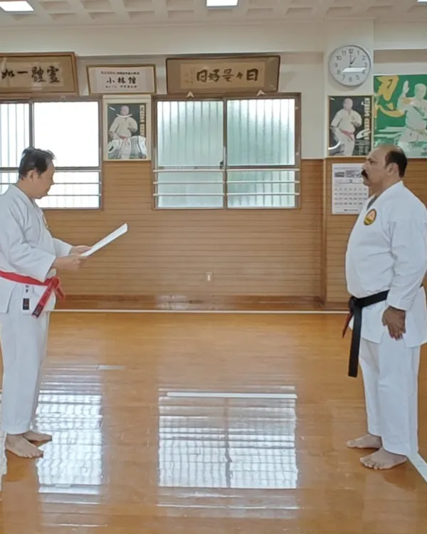 A formal moment at the Shorin-ryu Shorinkan Honbu Dojo in Okinawa as Hanshi Minoru Nakazato reads the declaration for my Kyoshi Nanadan (7th Dan) rank. This connection to the source is vital.