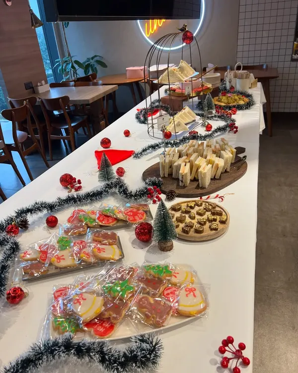 A full view of the high tea setup I did for Christmas celebrations at Ethos HQ. The table is filled with sandwiches, cookies, a chocolate fountain, and other festive treats.