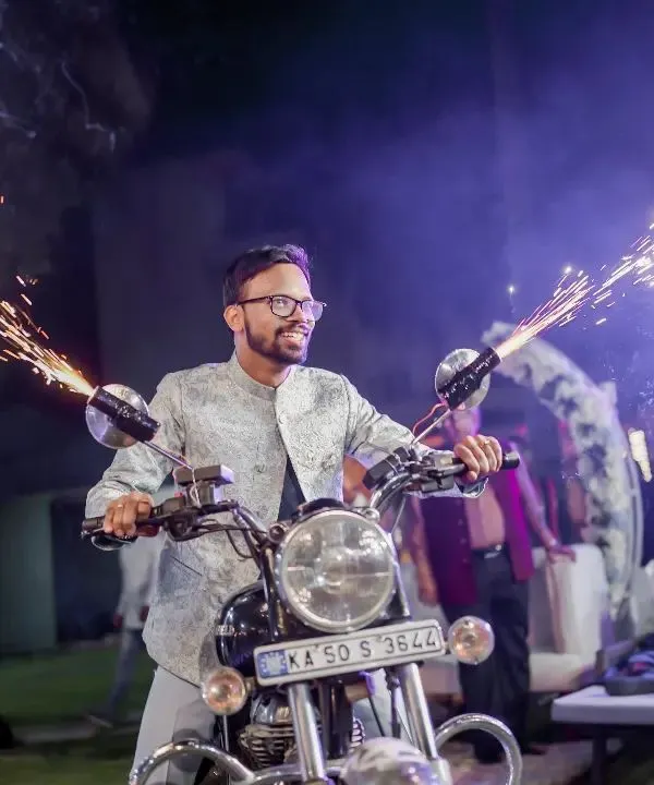 Making sure the groom's entry is nothing less than a blockbuster movie scene. This dashing entry on a Royal Enfield with cold fire pyrotechnics is how you make an unforgettable statement.
