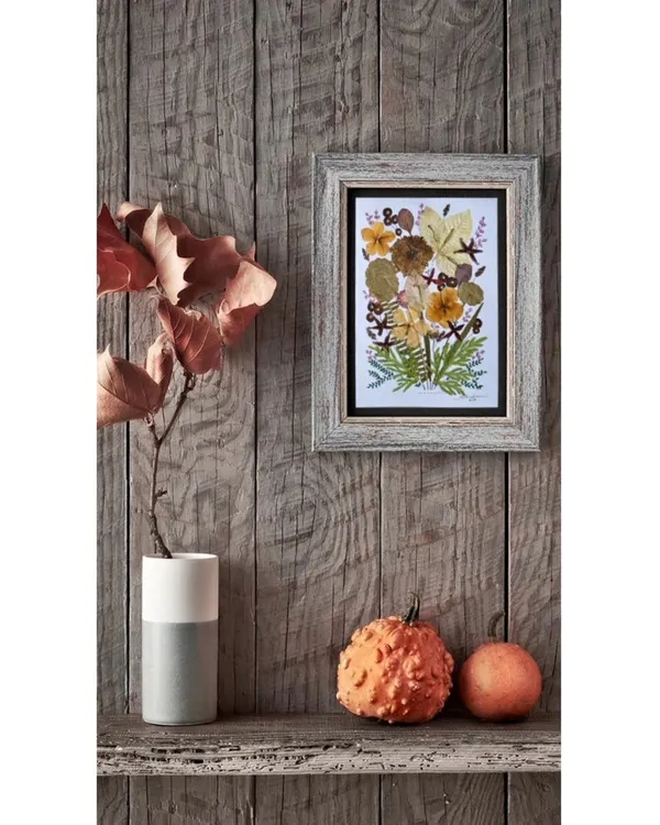 This piece is made from real pressed flowers and leaves that I've collected from my travels. It's a little piece of nature, preserved forever in a frame.
