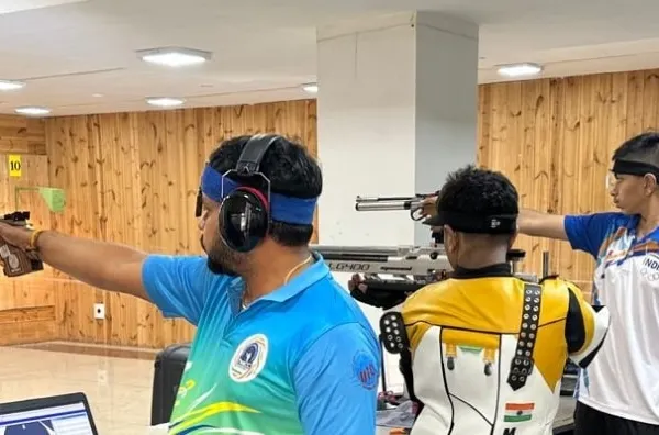 A close-up action shot of our pistol shooters during a training session. We offer professional coaching for all levels, from beginner experience sessions to advanced competitive training.