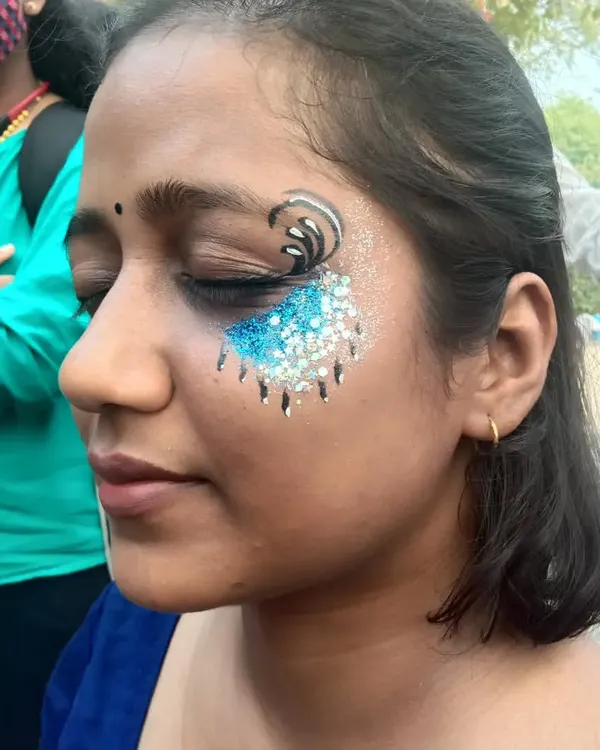 My signature dripping glitter effect. Here, I've combined a black swirl with a cascade of blue and silver glitter for a dramatic, eye-catching look.