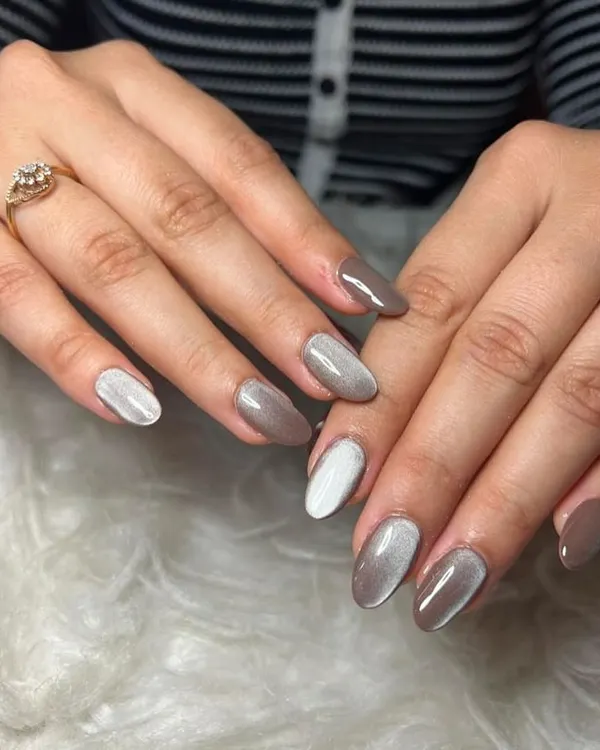 Cat-eye nails are so trendy. This set features a mix of a brown and a white cat-eye effect for a unique look.