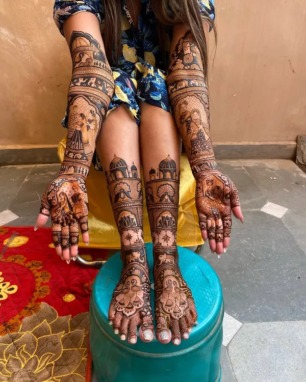 A complete bridal mehandi look, with matching designs for both hands and feet. The artwork features detailed portraits and traditional patterns, ensuring the bride looks perfect from head to toe.