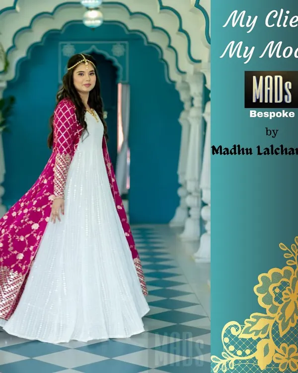 This is one of my favorite creations, a custom Indo-Western gown. I designed this elegant white anarkali paired with a vibrant pink, hand-embroidered long jacket for a client who wanted a modern yet traditional look for her special event.