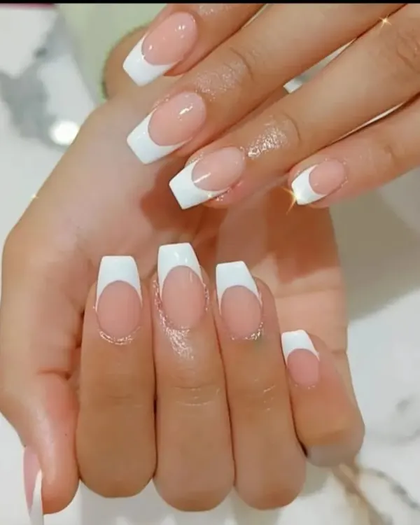 The perfect classic French manicure on long, coffin-shaped nails. The lines are crisp and the finish is glossy and flawless.
