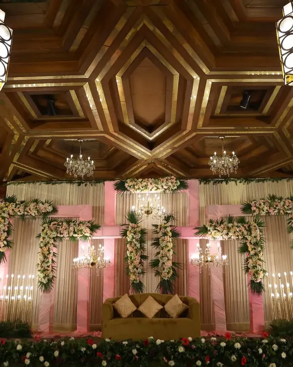 The stunning stage and ceiling decor of a wedding venue. We capture wide shots to show the full scale and ambiance of your chosen location.