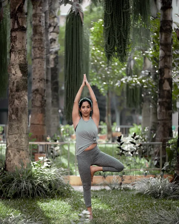 Finding stability in Vriksasana, or Tree Pose, surrounded by greenery. Practicing this grounding pose in nature is a powerful reminder of our connection to the earth and our own inner strength.