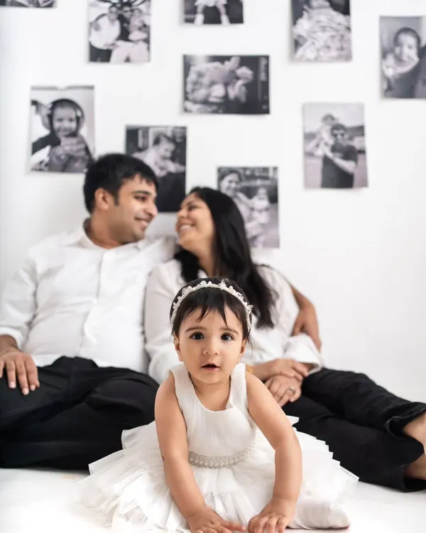 The birthday girl takes center stage in front of a backdrop filled with her family's cherished memories.