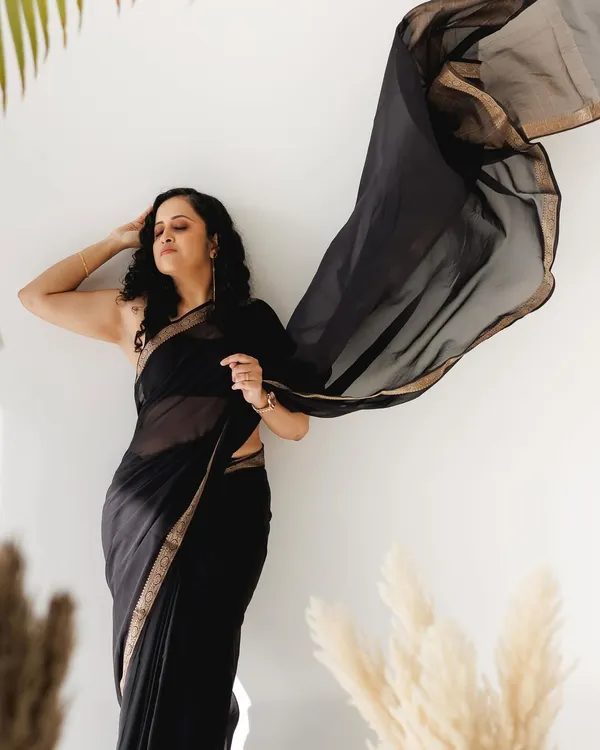 A dramatic pose with a flowing black saree. For this look, I kept the makeup very minimal and focused on a flawless, glowing skin finish to complement the simplicity and elegance of the saree.