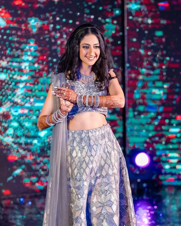 Ready to own the dance floor. This bride's sangeet makeup was all about shimmer and shine, with sparkling silver eyeshadow and a flawless base that stayed put all night long.