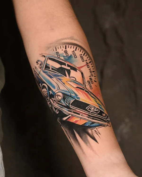 A fusion of mechanical precision and artistic freedom. This color realism tattoo of a classic car uses a vibrant watercolor splash to create a sense of speed and energy, while the car itself is rendered in crisp detail.