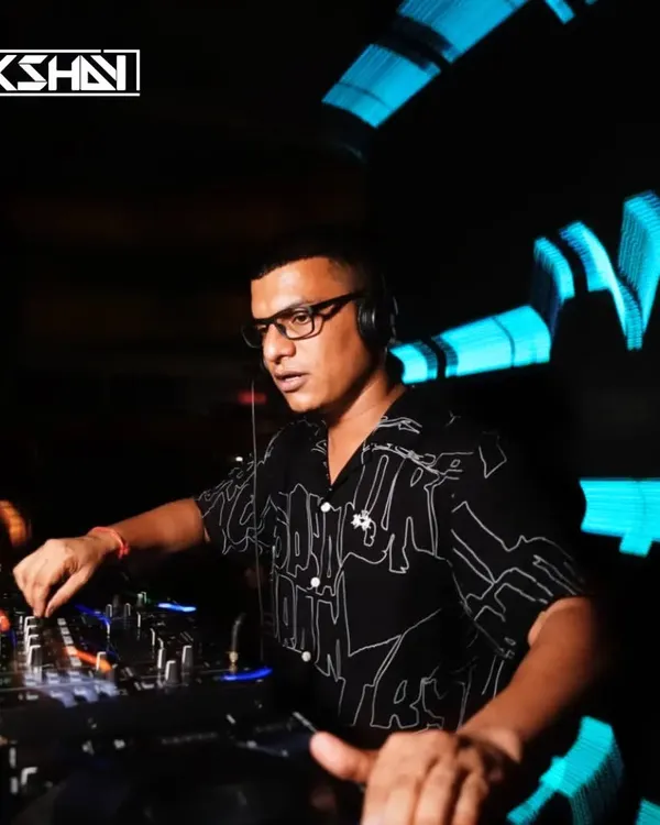 Locked in at the console, surrounded by the club's dynamic lighting. I focus on creating a seamless mix of house and techno tracks to keep the party going.