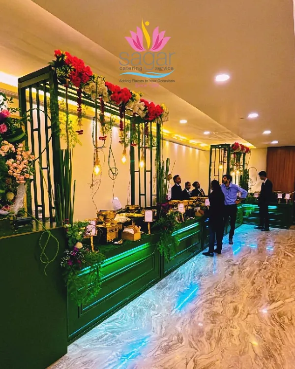 This is one of my signature Green and Gold themed buffet setups. I designed it to feel both grand and fresh, using lush florals, warm Edison bulb lighting, and elegant golden serving dishes to create a luxurious dining atmosphere for the wedding guests.