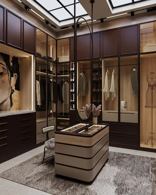This dream dressing room features rich, wine-toned cabinetry paired with warm wood finishes. A custom central island holds accessories, while a swivel mirror adds sculptural charm and function.