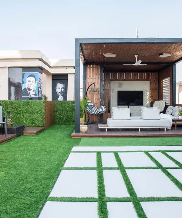 This is the main view of the penthouse terrace I designed. It features a wooden pergola for shaded seating, an open lawn area for gatherings, and a dedicated bar space, all designed to maximize the stunning city views.