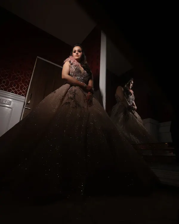 A dramatic, low-key portrait of a bride in her magnificent gown. The use of shadow and light creates a powerful and artistic image.