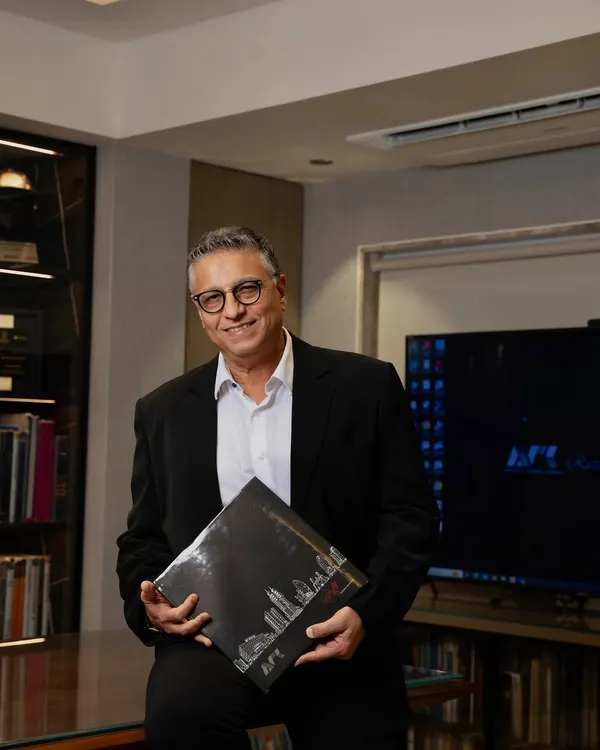 A portrait of me in my office. With over 37 years of architectural excellence, my philosophy is to liberate spaces, blending artistry, function, and sustainability to create designs that inspire and stand the test of time.