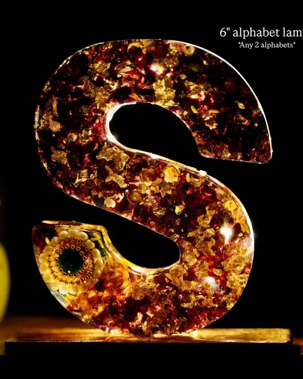 A 6-inch alphabet lamp, in the letter 'S', made with preserved flowers and gold flakes. These lamps come in a set of any two alphabets.