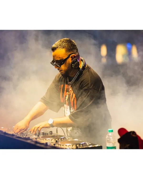 I’m not just playing tracks, I’m creating a whole atmosphere. Here I am, lost in the mix and the smoke, crafting the perfect vibe for the crowd at the Artist Connect Dance Music Festival.