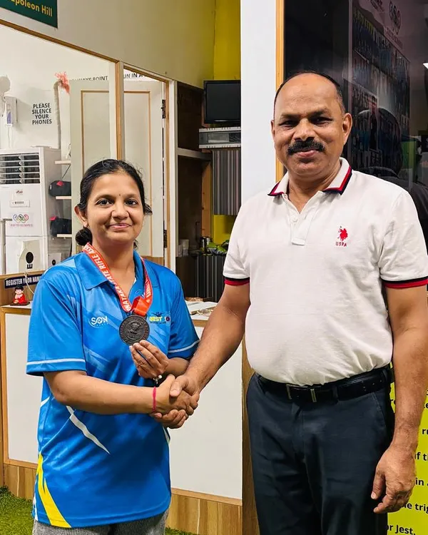 A handshake of congratulations. A proud moment with one of our medal winners at the academy after her success in the Air Rifle event.