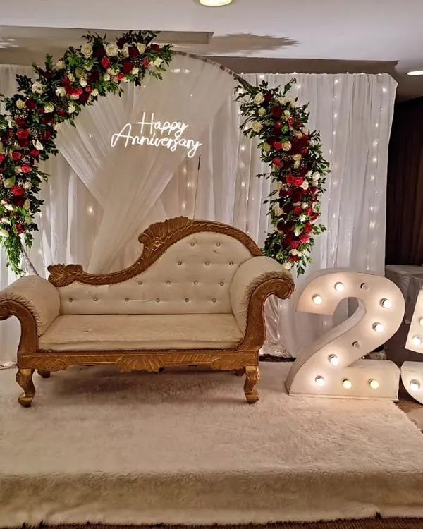 A classic and elegant setup for a 25th anniversary celebration. We used a floral arch, a "Happy Anniversary" neon sign, and large illuminated numbers to create a beautiful focal point for the happy couple.