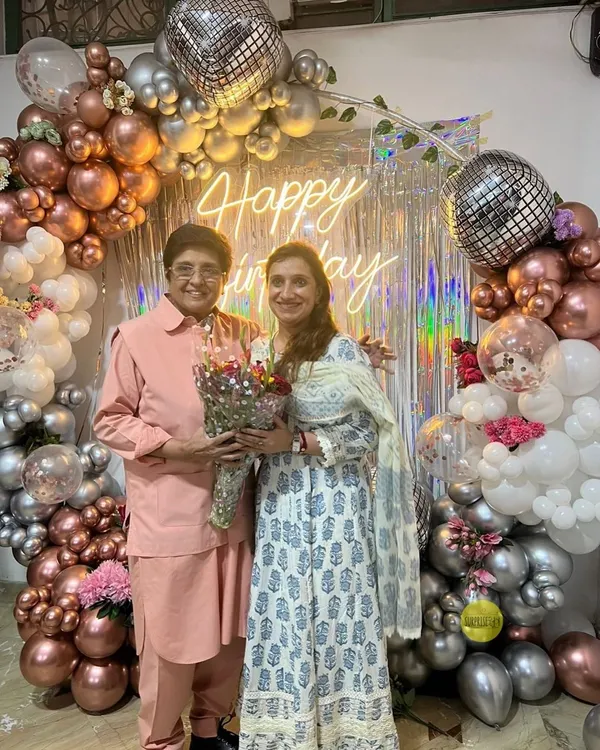 We were honored to create this glamorous backdrop for Kiran Bedi's birthday. The setup featured a "Happy Birthday" neon sign, a shimmering silver curtain, and a lush arch of chrome and white balloons with disco ball accents.