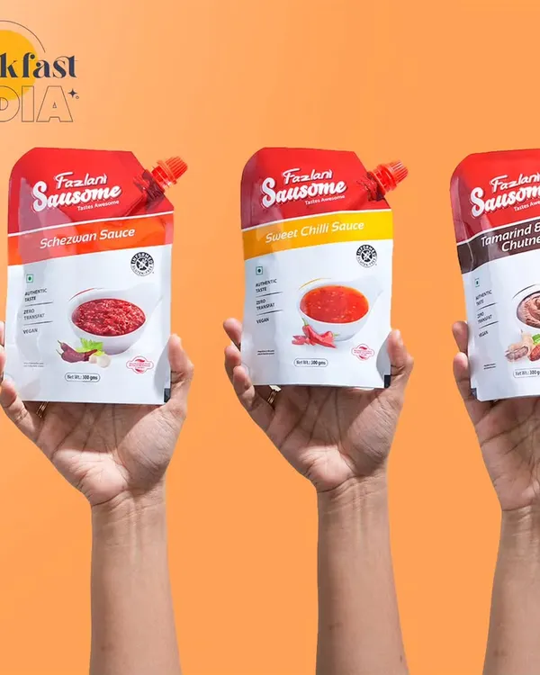 This shot uses a simple, effective concept to showcase product variety. Having hands hold up the different sauce pouches against a bright, solid background is a clean way to display the range.
