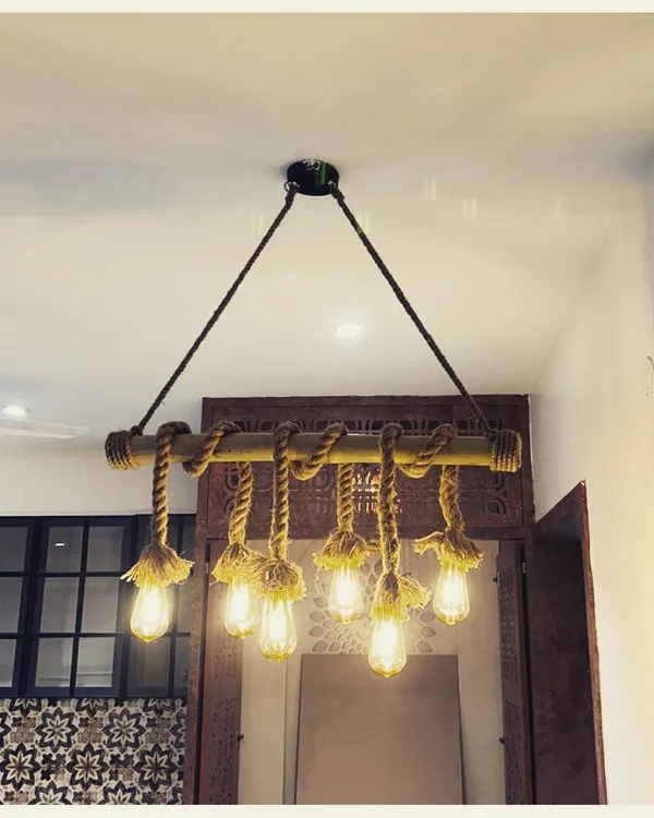 This handcrafted light fixture tells a story of rustic charm. We used a bamboo rod and natural rope to suspend multiple Edison bulbs, creating a warm and characterful centerpiece that elevates the entire space.
