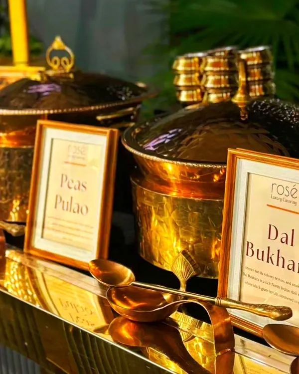 A close-up of our signature Dal Bukhara and Peas Pulao, served in magnificent hammered-brass pots. Our unwavering dedication to culinary mastery ensures a flawlessly executed event that will captivate your guests.