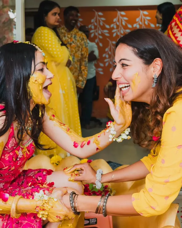 A moment of pure joy and mischief during the Haldi ceremony. We love capturing the candid laughter and playful interactions that make this event so special.