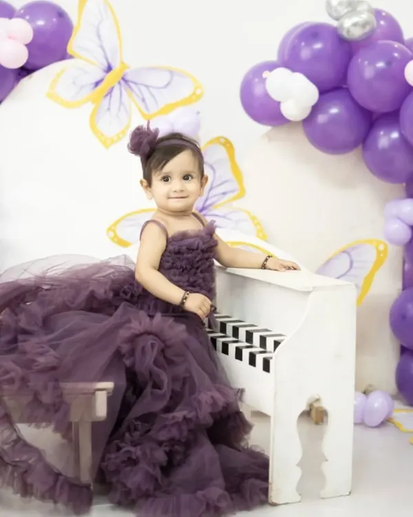 Planning a pre-birthday shoot for your little princess? This grand mauve ruffle gown will make her feel like she's in a fairytale. It's available for both rent and purchase.