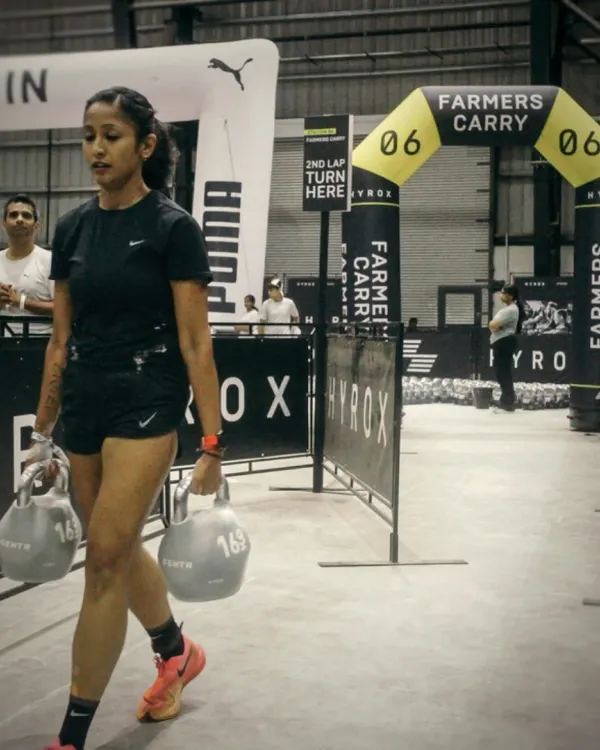 This is what hybrid training is all about. The farmer's carry at a Hyrox event combines pure strength with endurance. It’s a test of physical power and mental grit, a core part of my functional fitness programs.